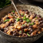 Close-up of grey peys and bacon made from carlin peas in a bowl with parsley garnish.