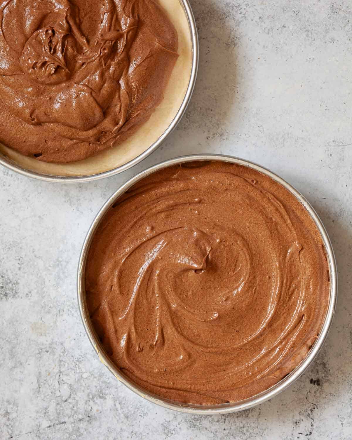 Batter in circular baking tins ready to be baked.