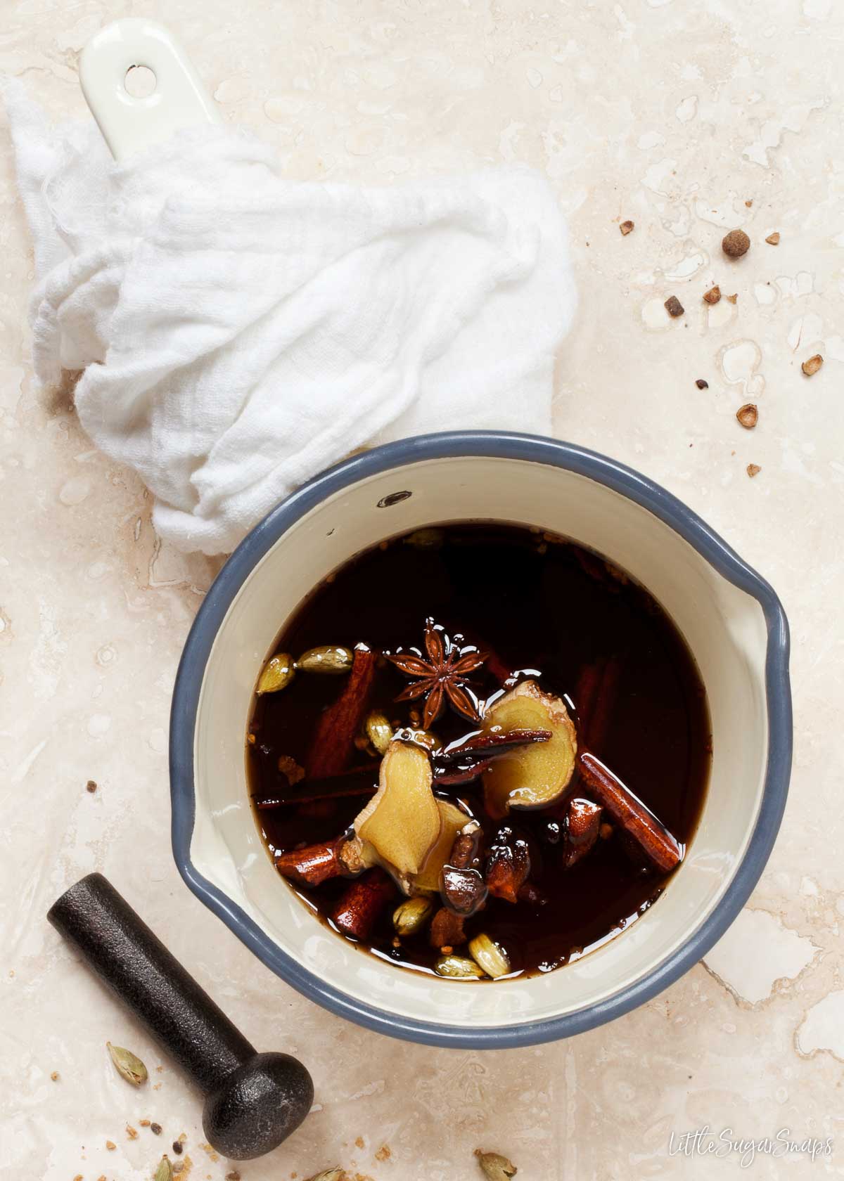 Chai latte syrup in a pan with spices steeping in it.