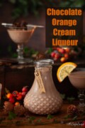 Labelled chocolate orange liqueur in a small bottle with glasses poured alongside.