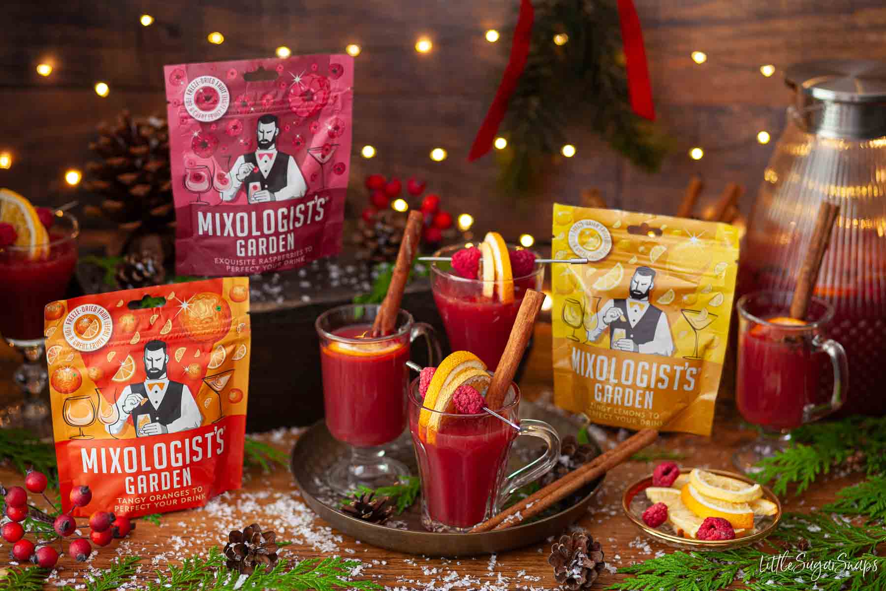 Glasses of alcohol free fruit punch mocktails with packets of freeze-dried drink garnishes alongside.
