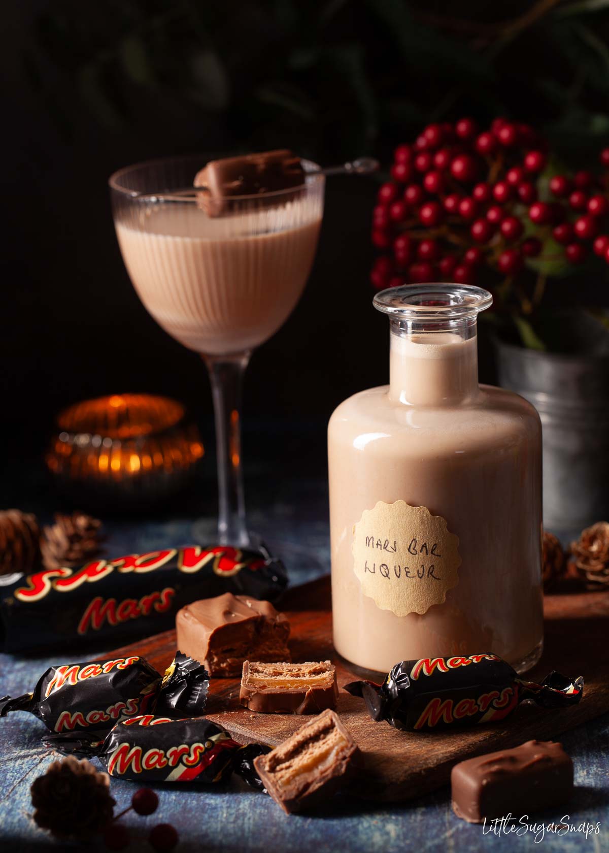 A bottle of Mars Bar liqueur with a serving in a glass behind it.