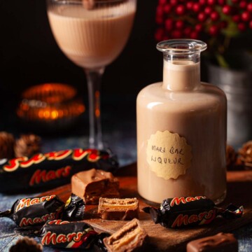Close up of a bottle of creamy chocolate liqueur miniature chocolate bars alongside.