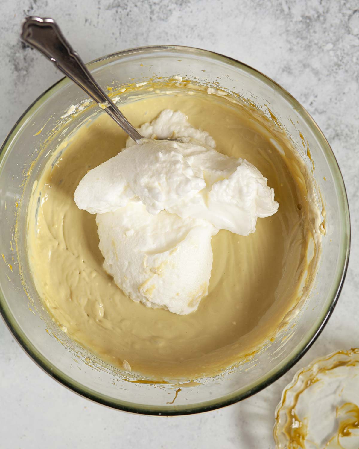 Whisked egg whites about to be folded into pistachio mascarpone cream.