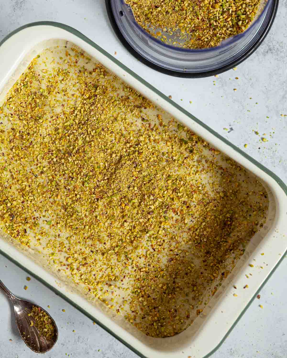 Ground pistachio nuts sprinkled over the top of a pistachio cream dessert.