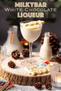 Labelled image of white chocolate liqueur served over ice with a Milkybar cowboy garnish.