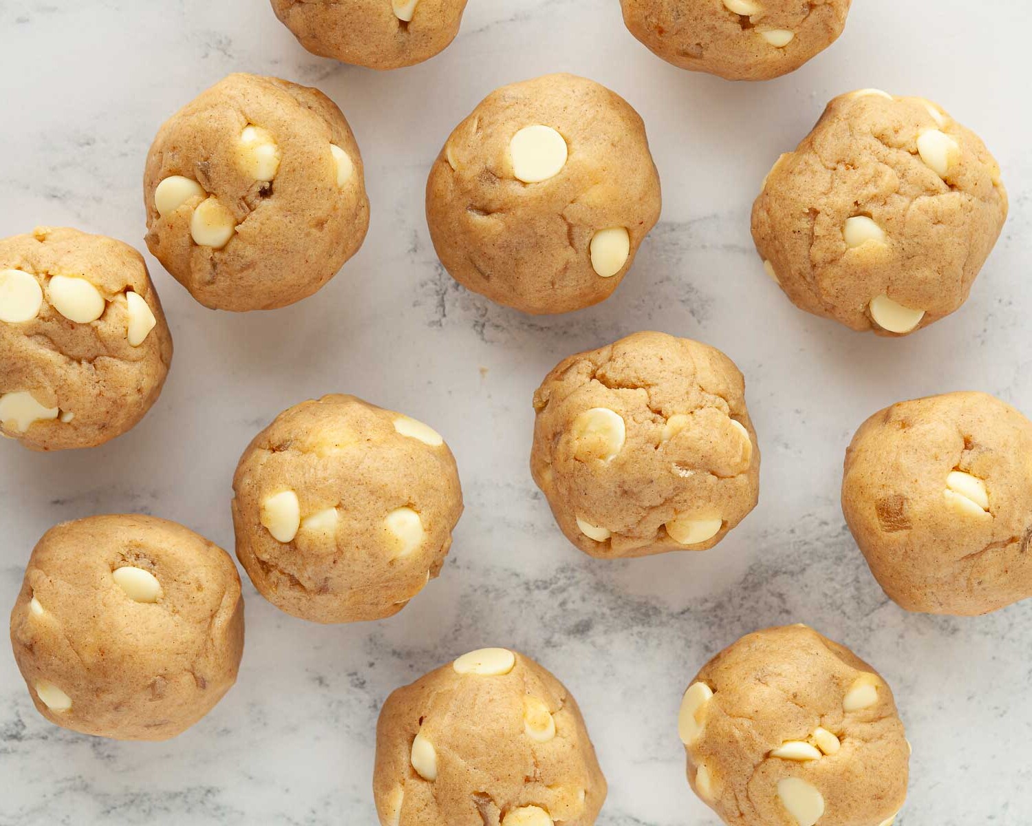 Stem ginger cookie dough shaped into balls ready for baking.