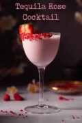 Labelled image of creamy strawberry liqueur cocktail with freeze-dried fruit rim and strawberry garnish.