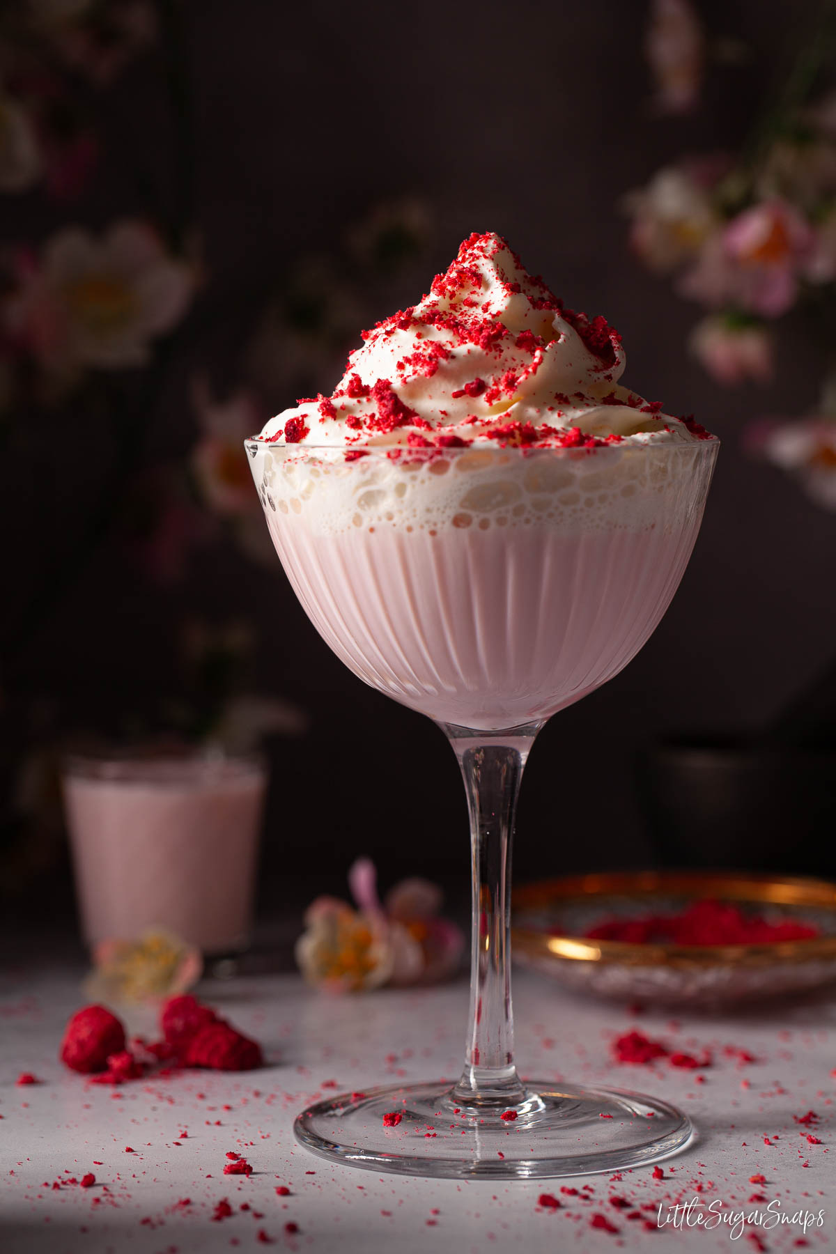 Tequila Rose cocktail topped with cream and crushed freeze-dried raspberries.