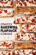 Labelled cherry and almond flapjack with icing, cherries and almonds on the top.