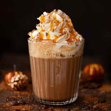 Caramel mocha drink topped with whipped cream, chocolate flakes and caramel syrup.