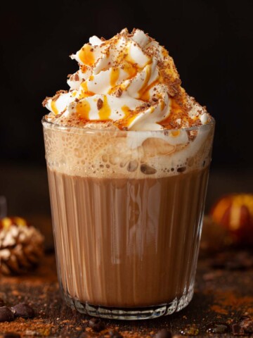 Caramel mocha drink topped with whipped cream, chocolate flakes and caramel syrup.