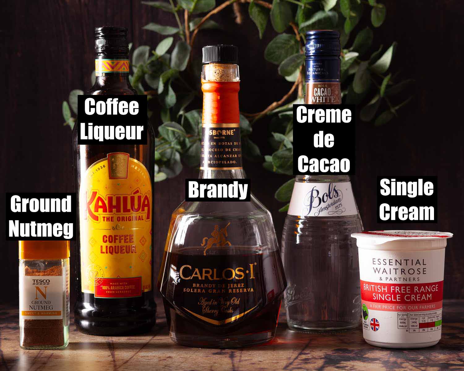 Ingredients for a coffee and brandy after dinner cocktail with text overlay.