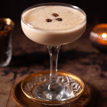 A creamy after dinner cocktail with nutmeg and coffee bean garnish.