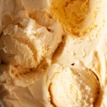 Salted honey ice cream with scoops removed from it.