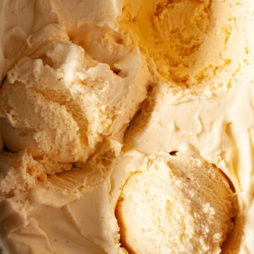 Salted honey ice cream with scoops removed from it.