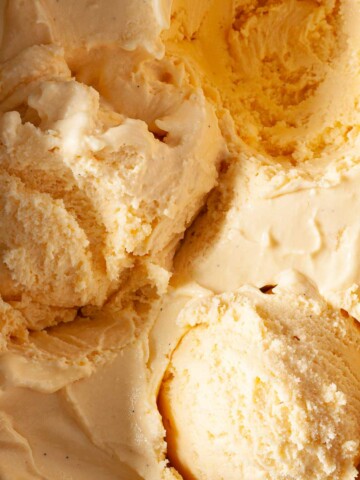 Salted honey ice cream with scoops removed from it.