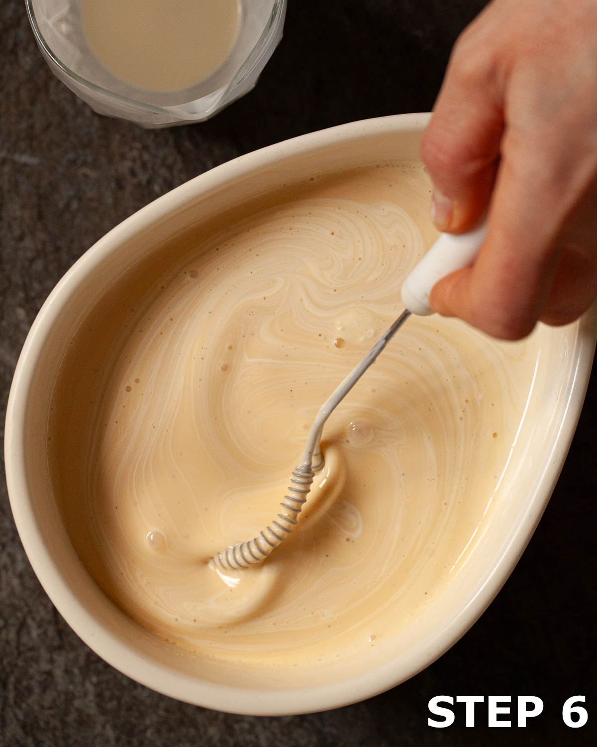 Cream being mixed into custard to make ice cream.