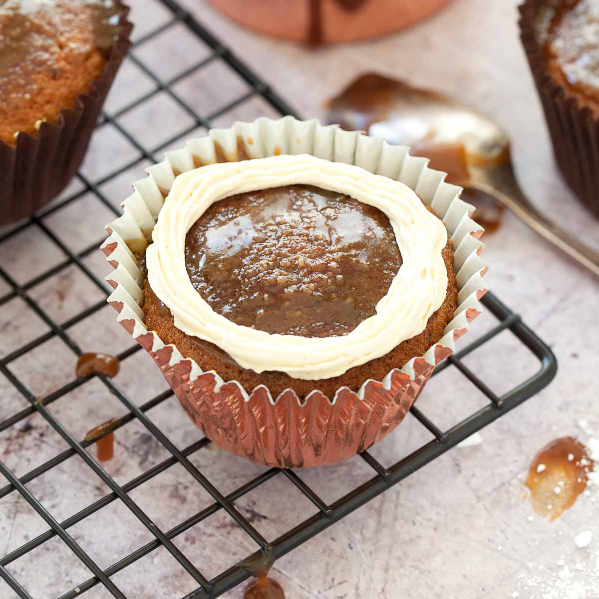 Decorating a sticky toffee cupcake with buttercream.