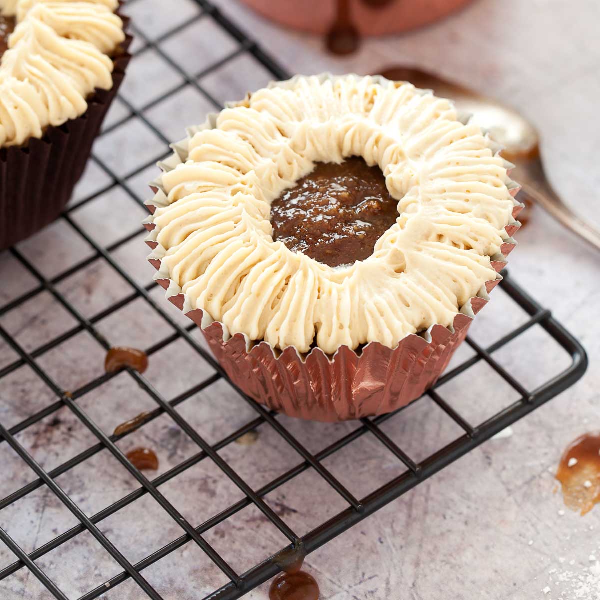 Decorating a sticky toffee cupcake with buttercream.
