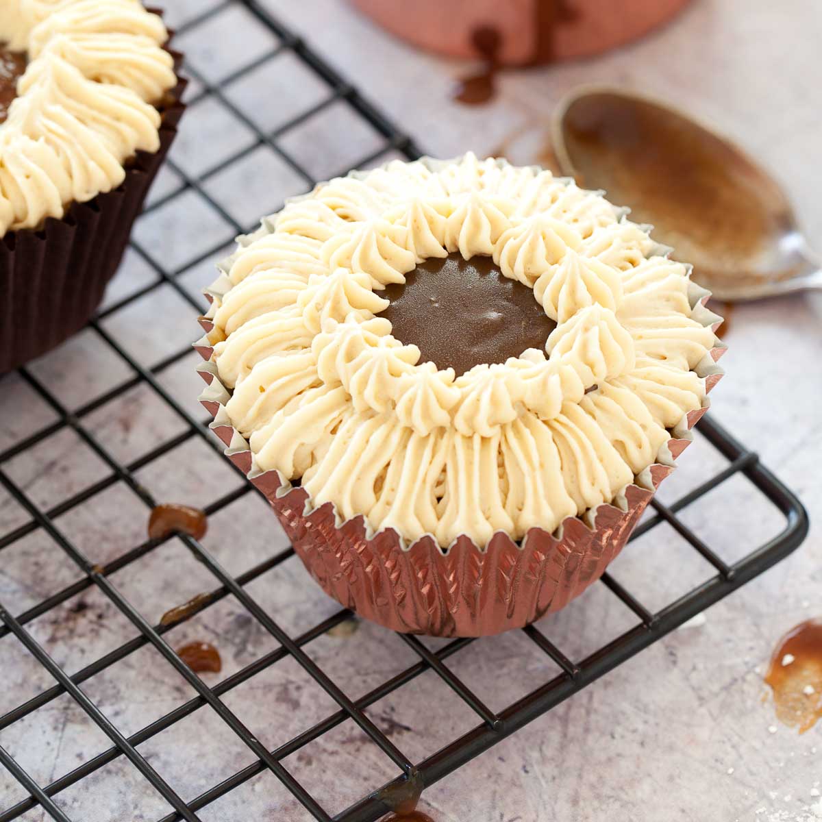 Decorating a sticky toffee cupcake with buttercream.