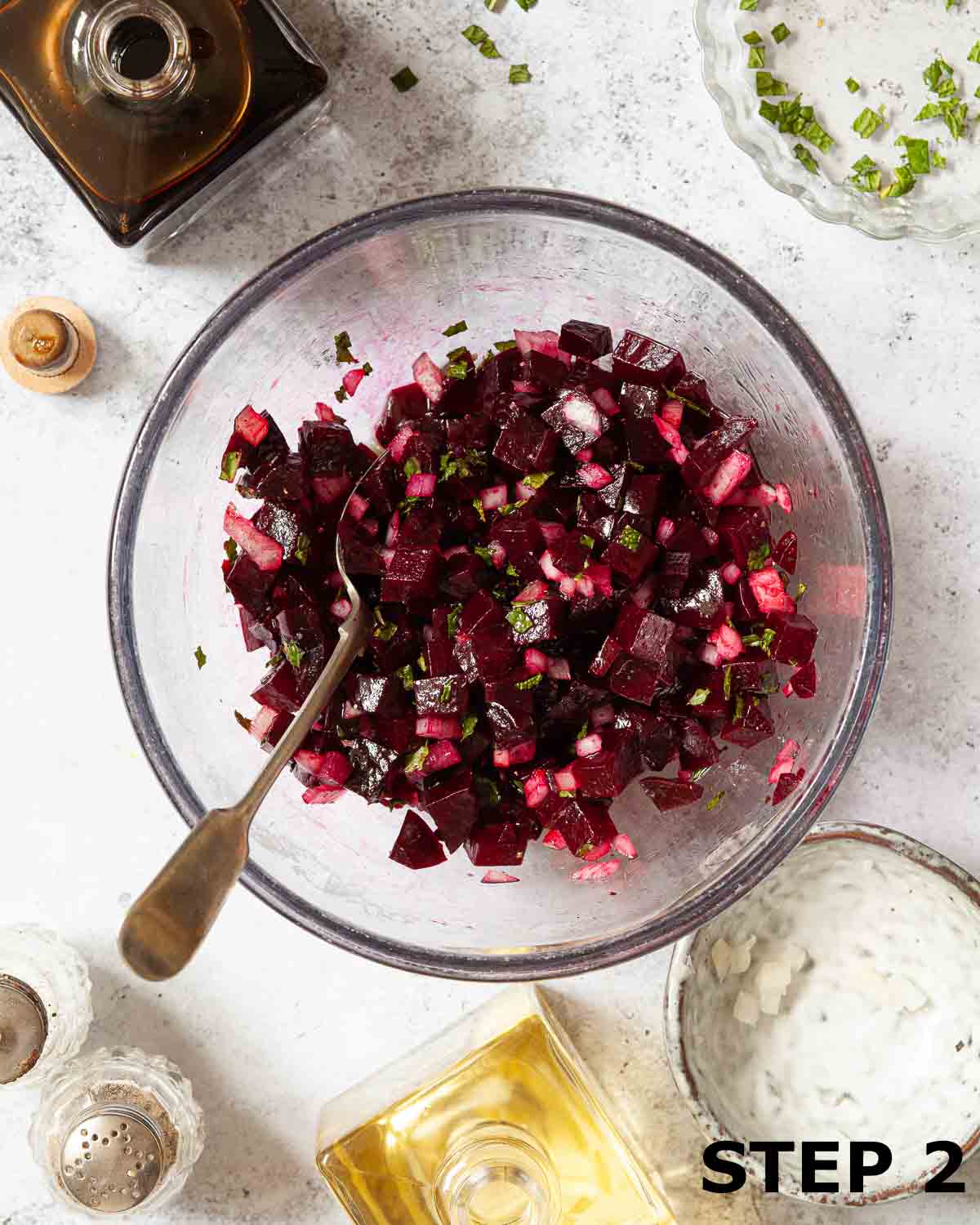 Beetroot, onion and mint in a bowl dressed with oil and balsamic vinegar.