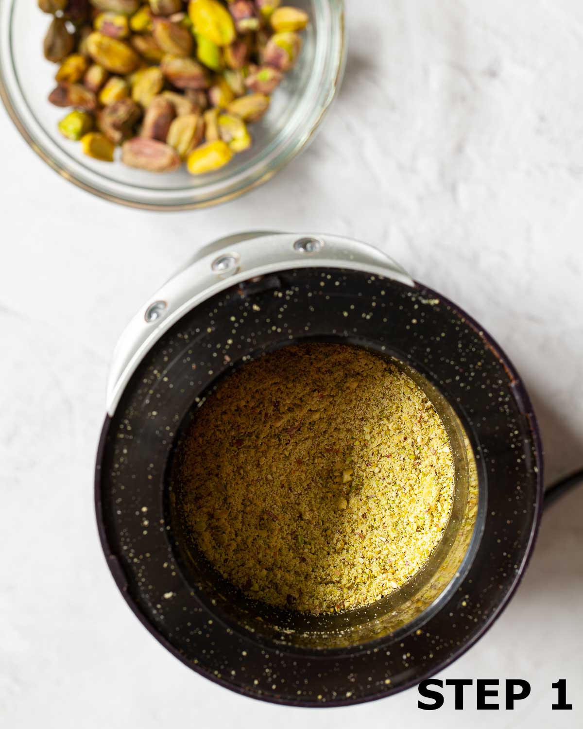 Ground pistachio nuts in a small grinder.