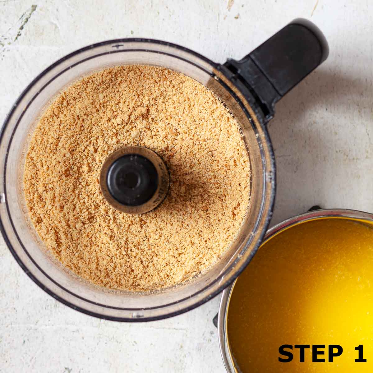 Biscuits crumbs in a food processor and melted butter in a saucepan.