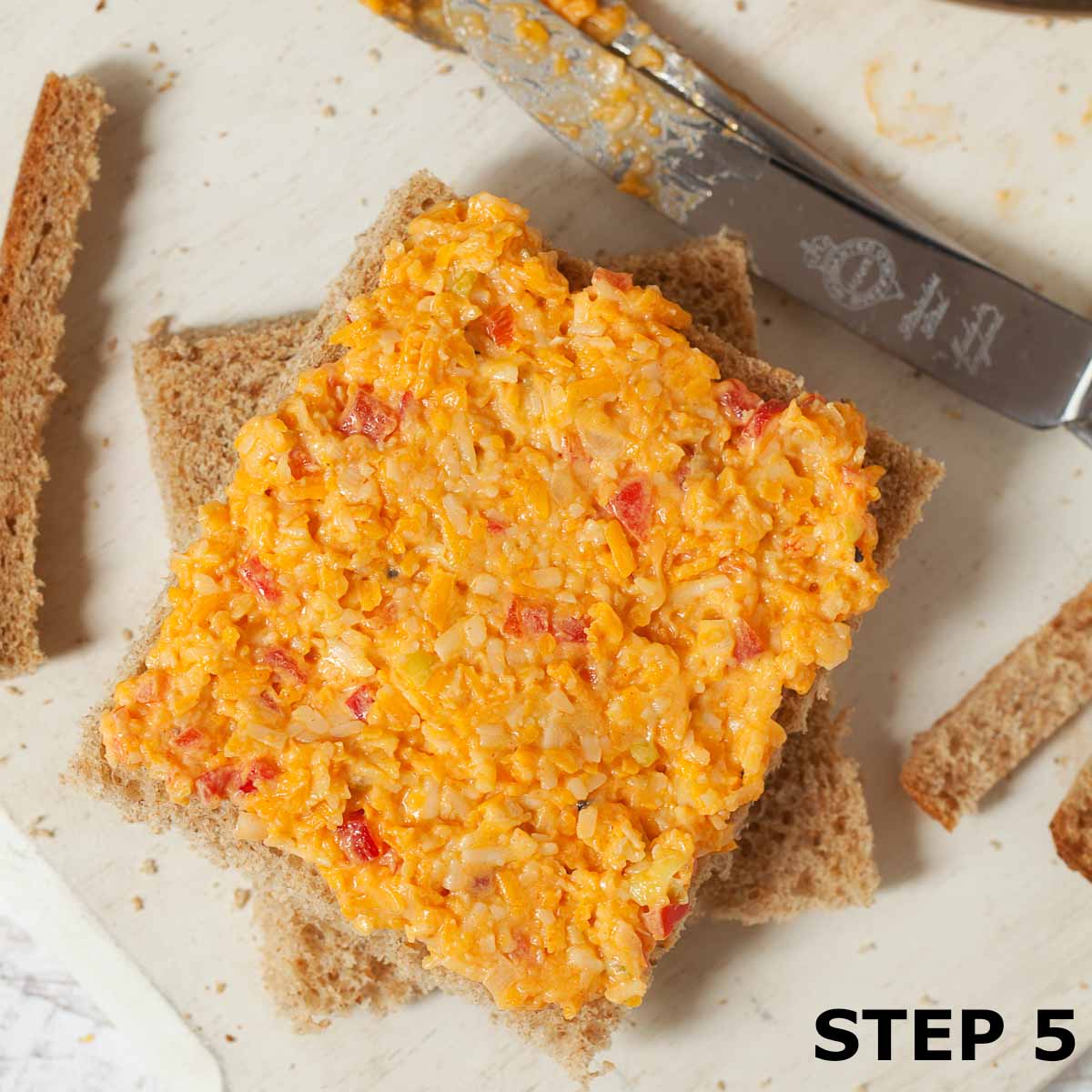 Cheese savoury sandwich filling spread on brown bread.