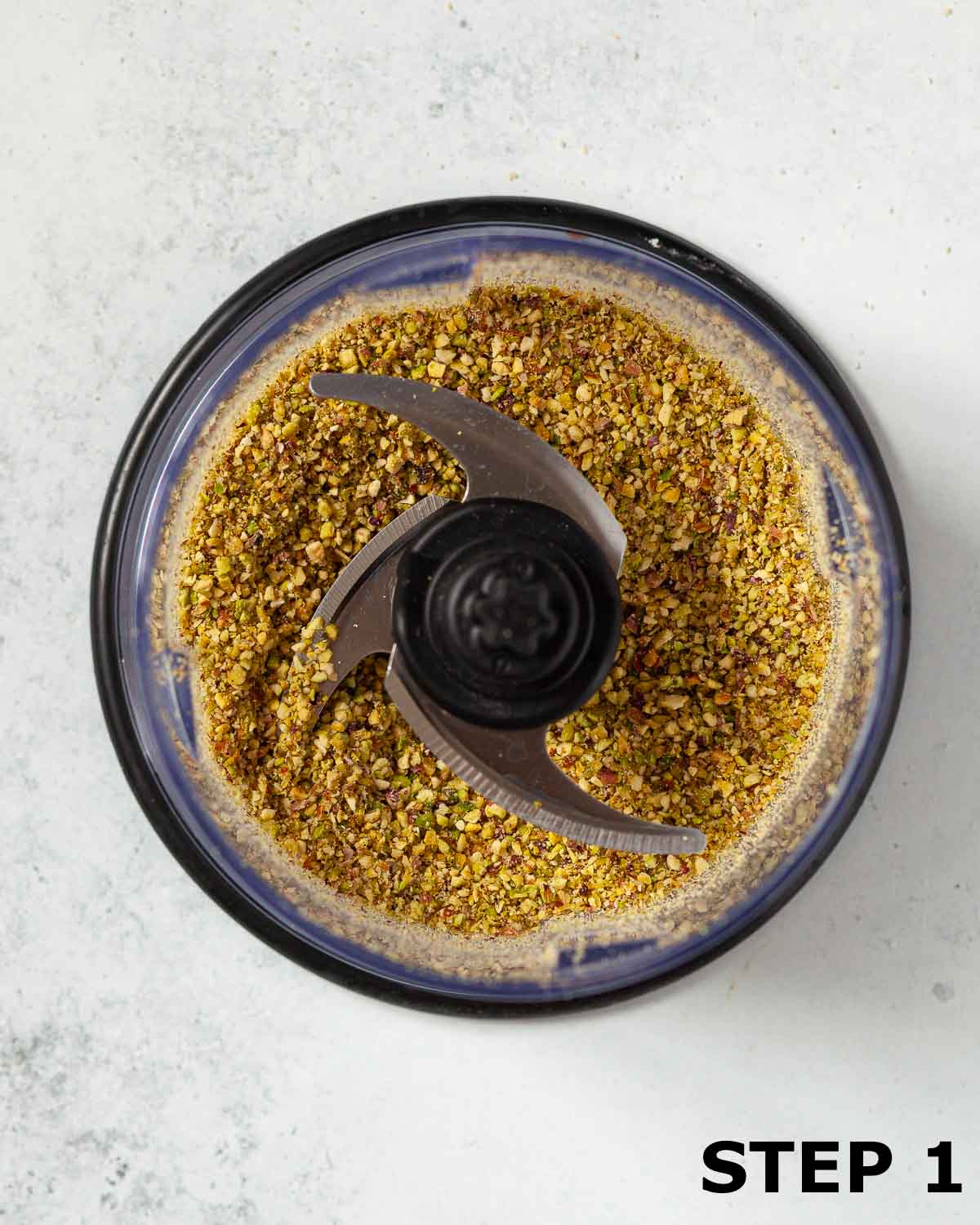 Chopped pistachio nuts in as food processor.