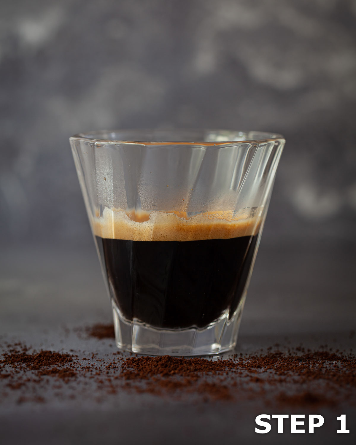 A shot of espresso coffee in a heatproof glass.