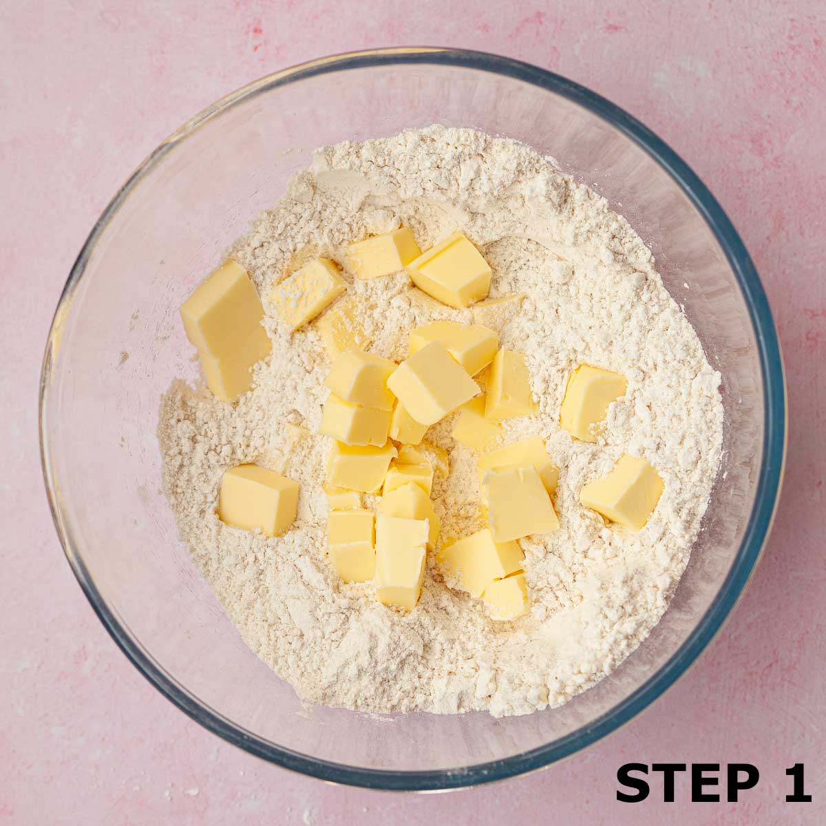 Flour and cubed butter in a mixing bowl.