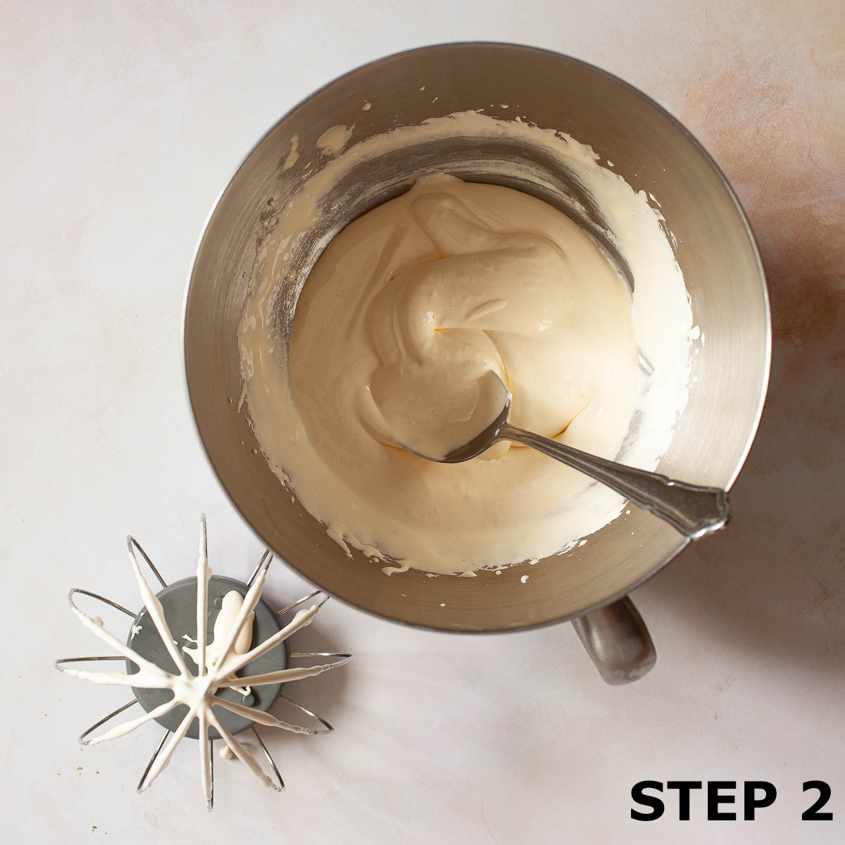 Egg yolk and sugar in a bowl having been whipped to the ribbon stage.
