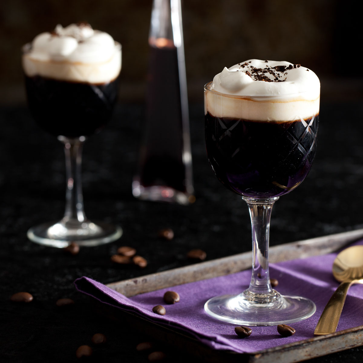 Almond and blackcurrant liqueur coffee topped with whipped cream and ground coffee