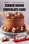 Labelled Kinder Bueno cake decorated with chunks of Bueno with a wrapped bar alongside.