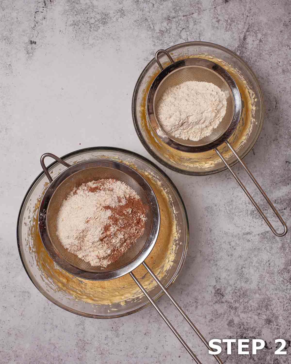 Flour and hot chocolate powder being sieved into bowl when making cake batter.