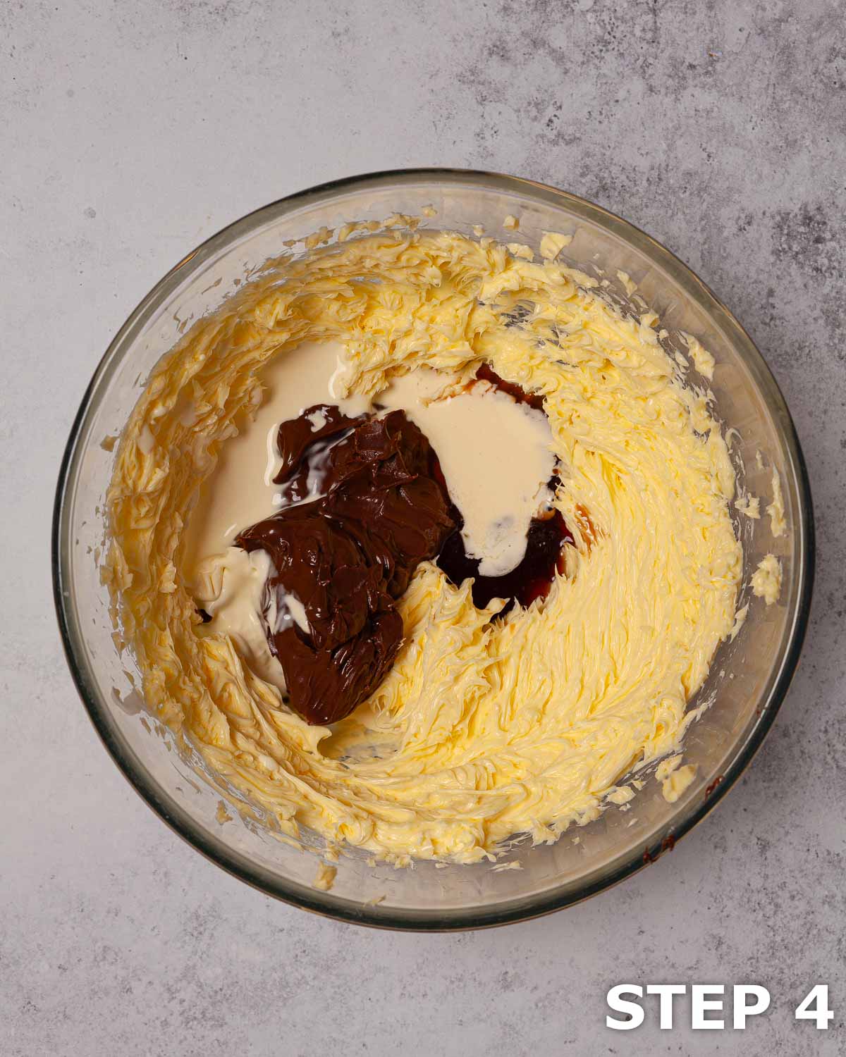 Creamed butter, cream and Nutella spread in a mixing bowl.