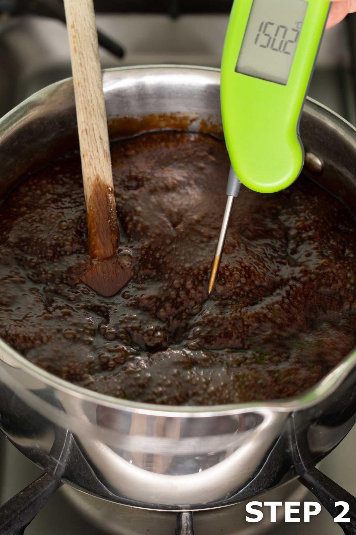 A digital food thermometer being used to test the temperature when making hard toffee.
