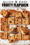 Squares of fruity flapjack with raisins on parchment with text overlay.