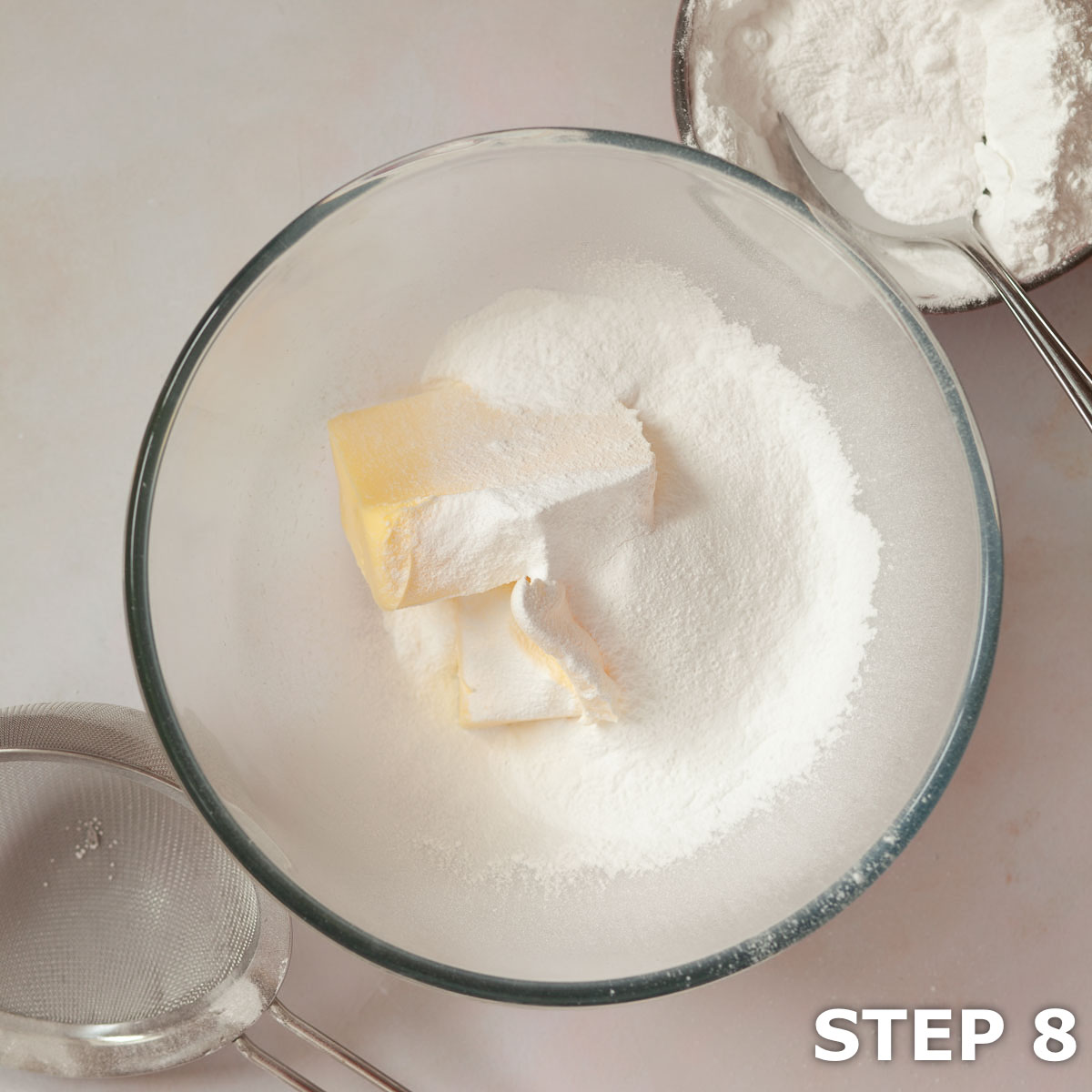 Butter and sieved icing sugar in a mixing bowl.