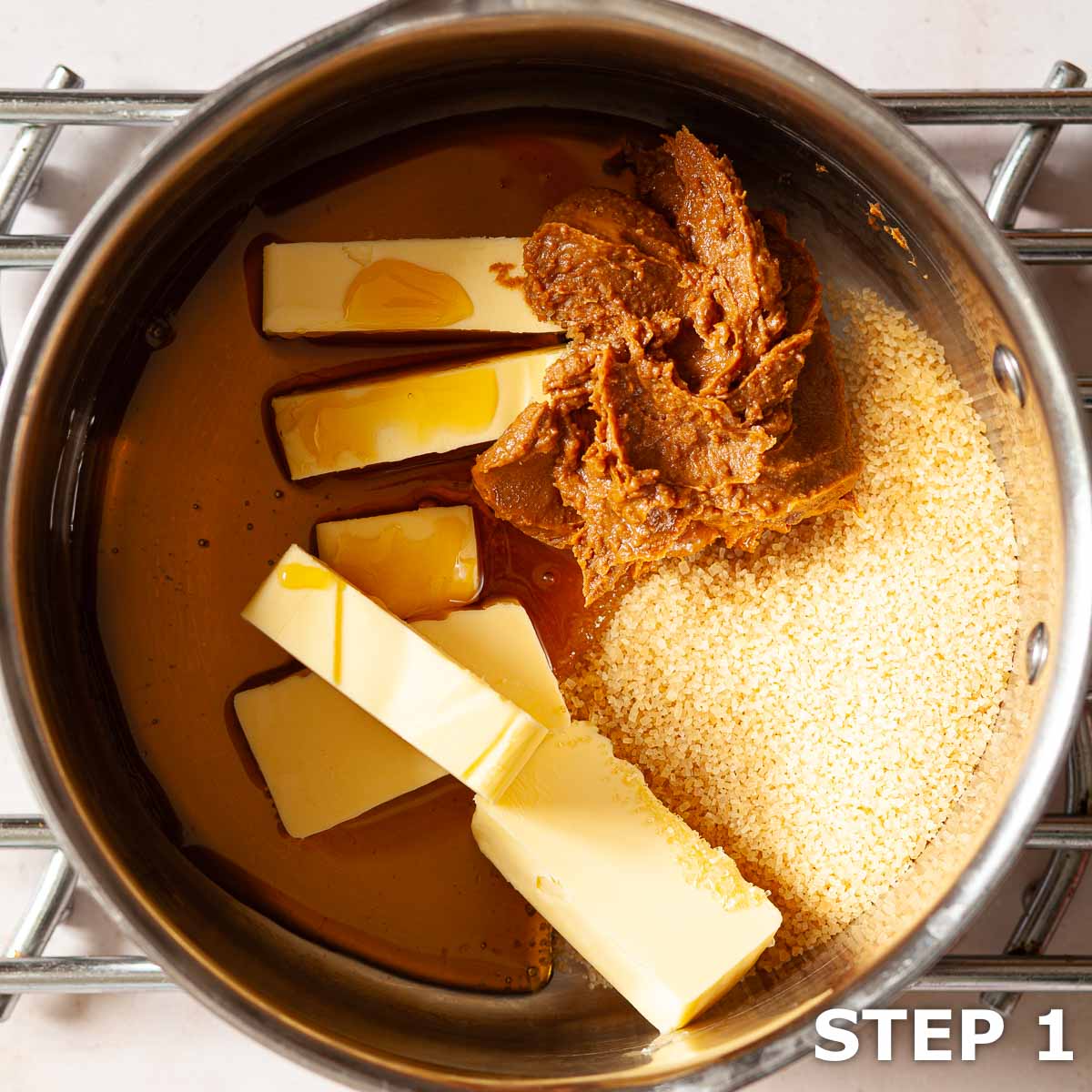 Butter, syrup, sugar and Biscoff spread in a saucepan for flapjack.