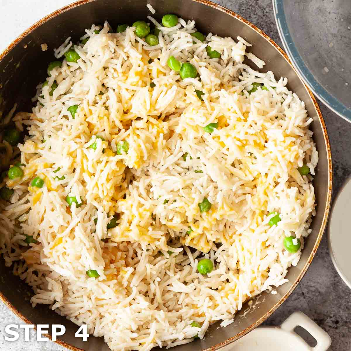 Egg fried rice being cooked in a pan.