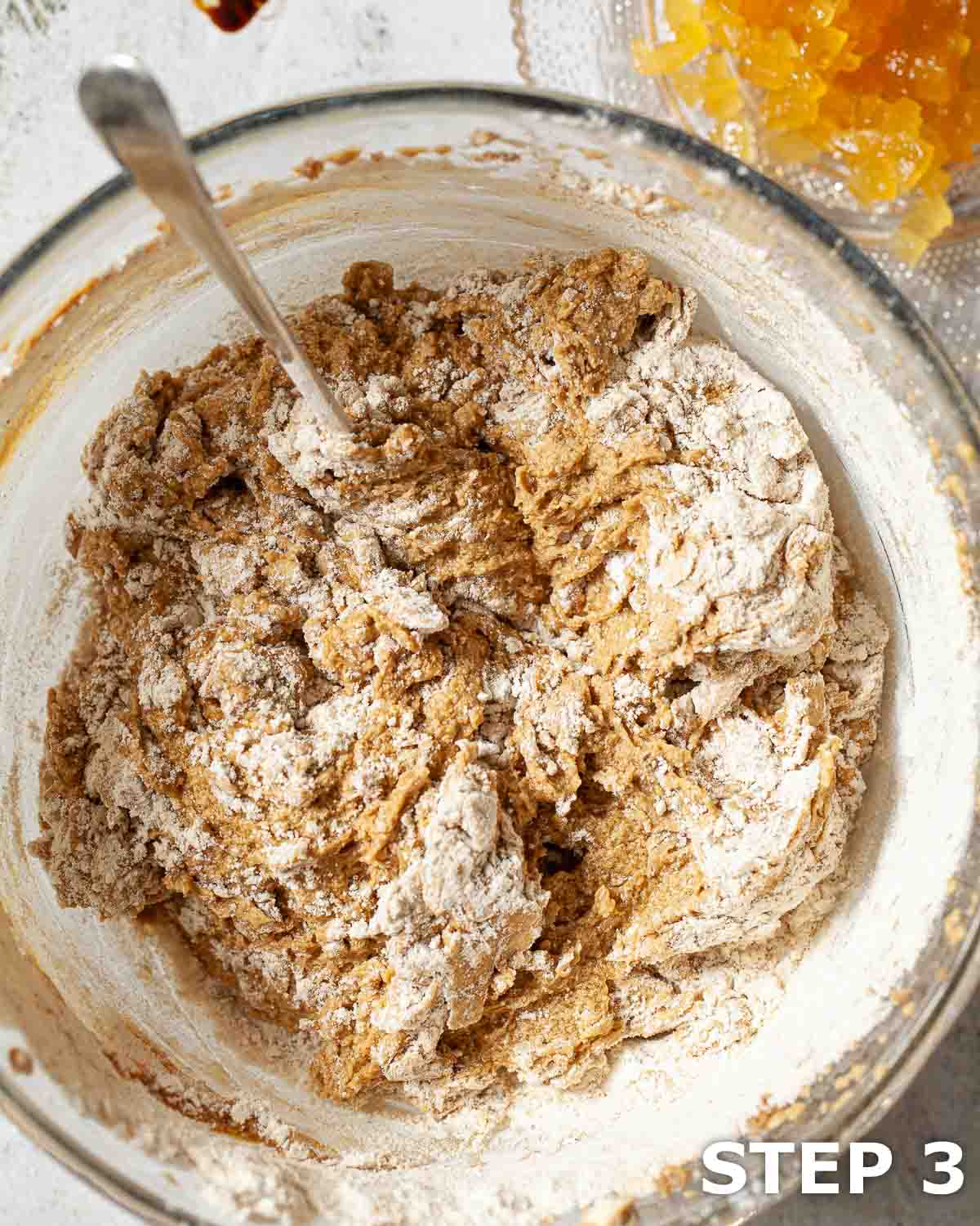 Flour partially mixed into batter for sticky ginger cake.