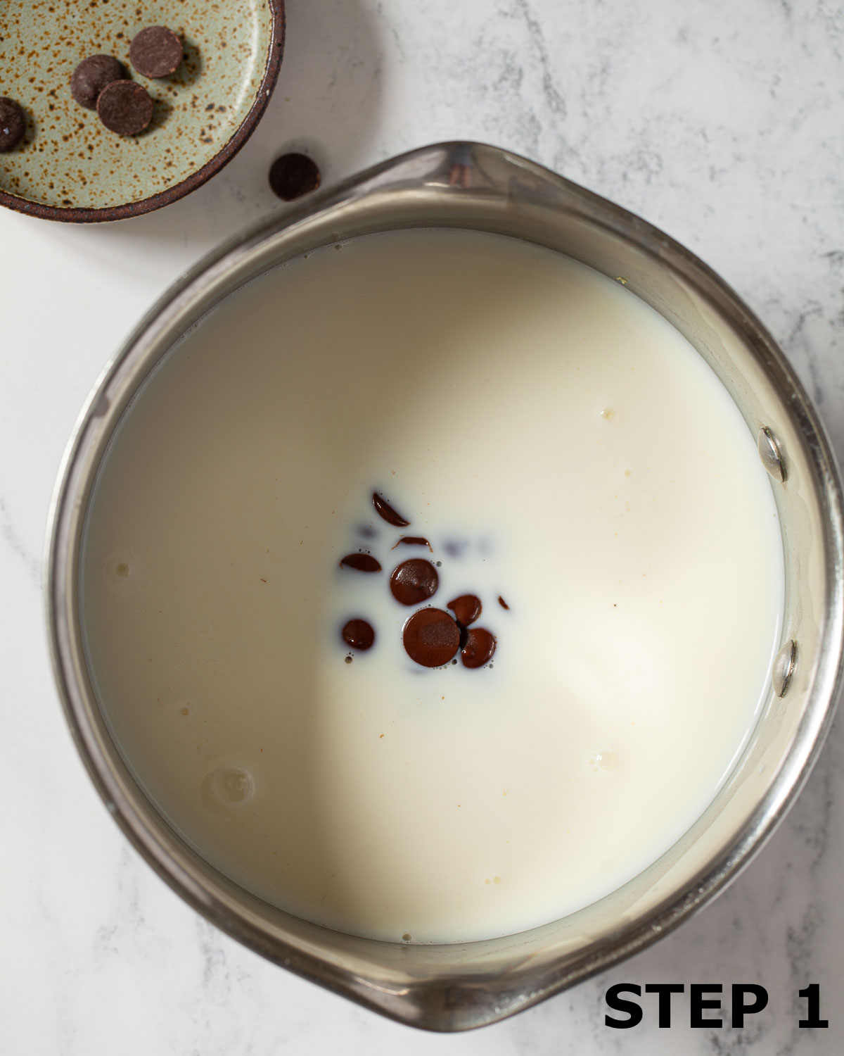 Chocolate chips in a pan of milk.