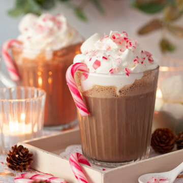 Candy cane hot chocolate topped with whipped cream, crushed candy cane and marshmallow.