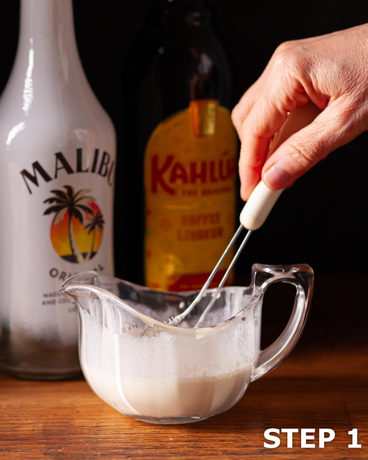 Person whipping cream using a small hand held whick.