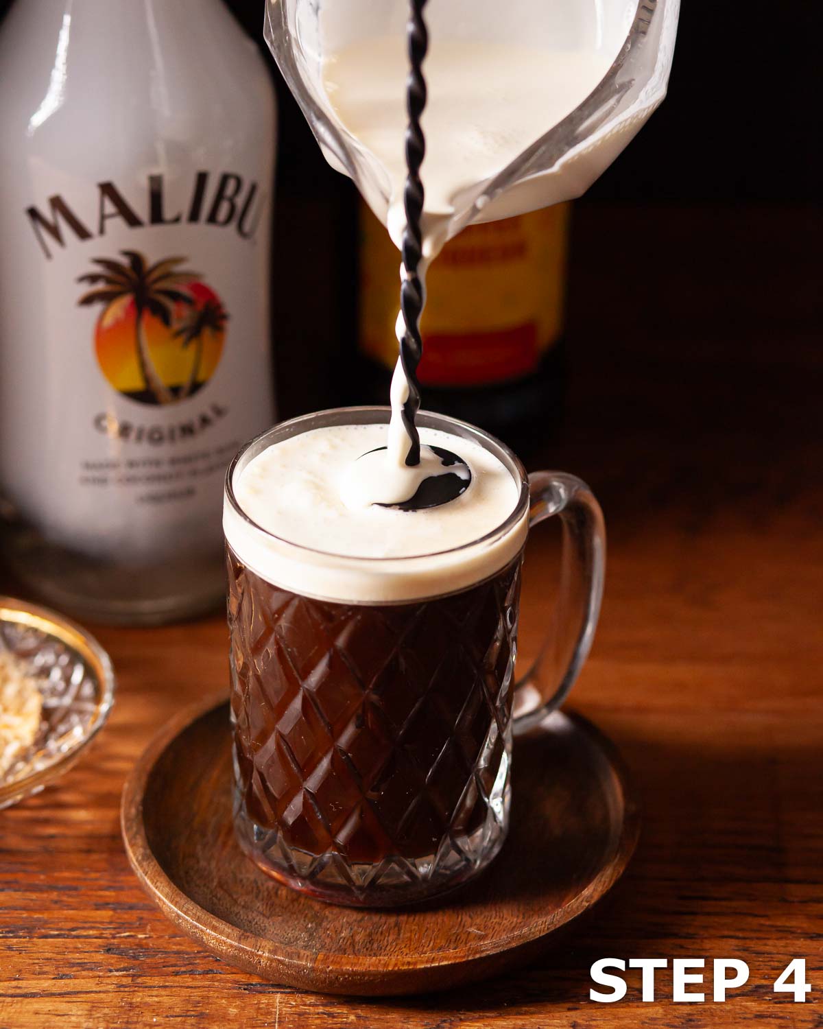 Cream being floated on a Malibu rum coffee drink.