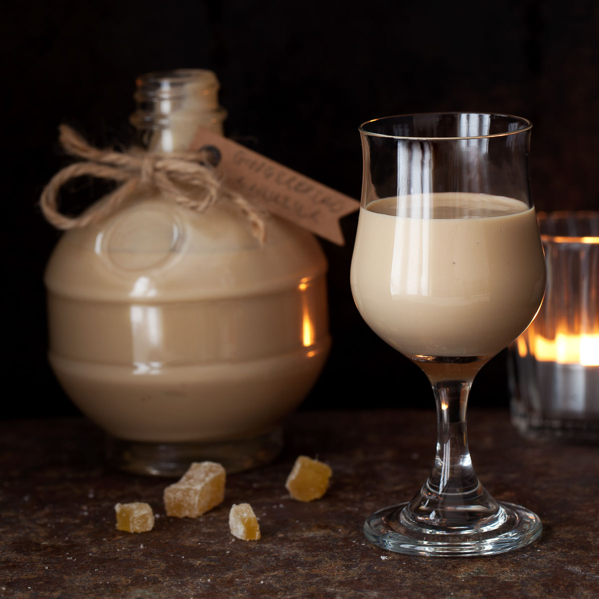 A glass of gingerbread cream liqueur with a bottle behind it.