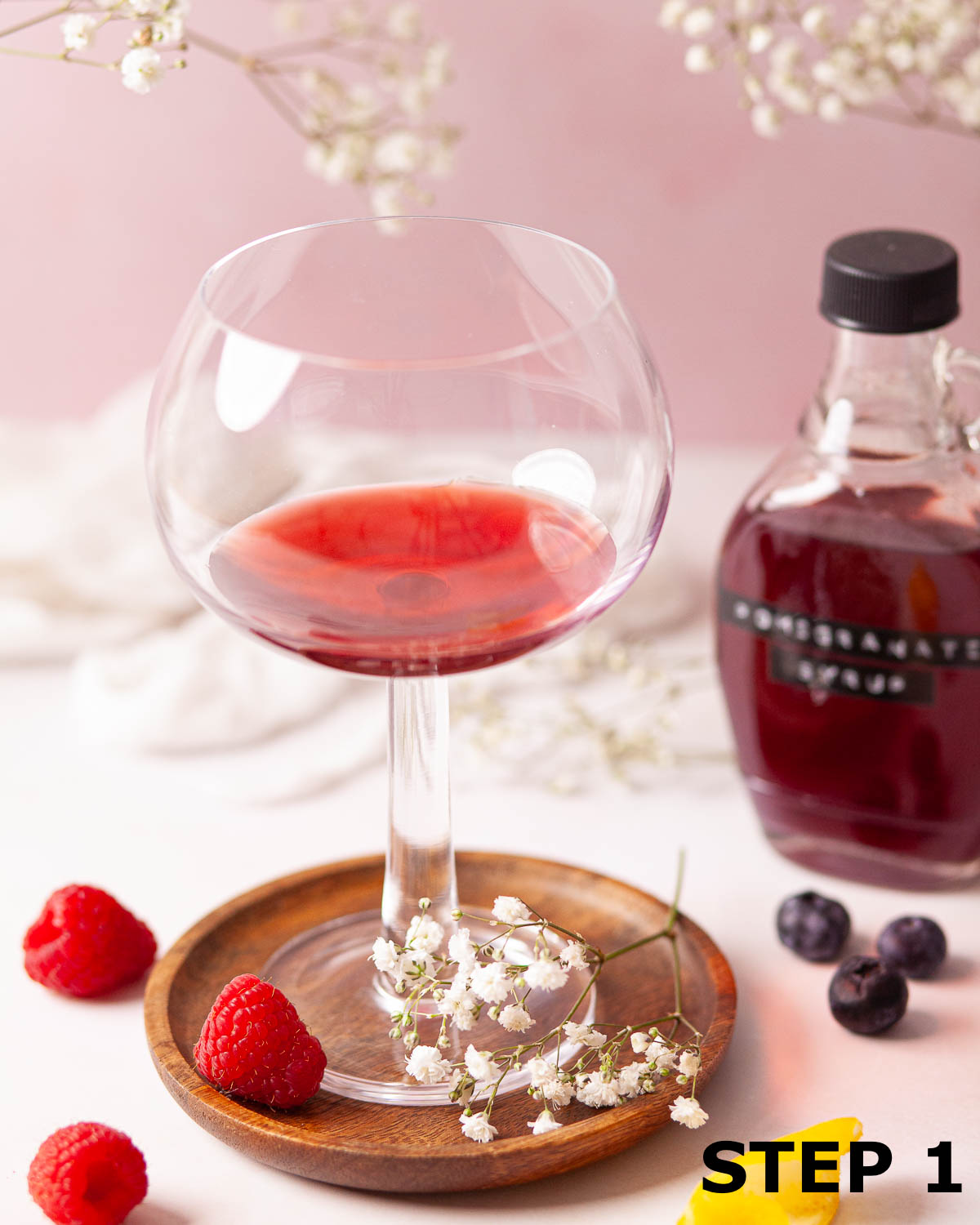 Pomegranate syrup in a copa glass.