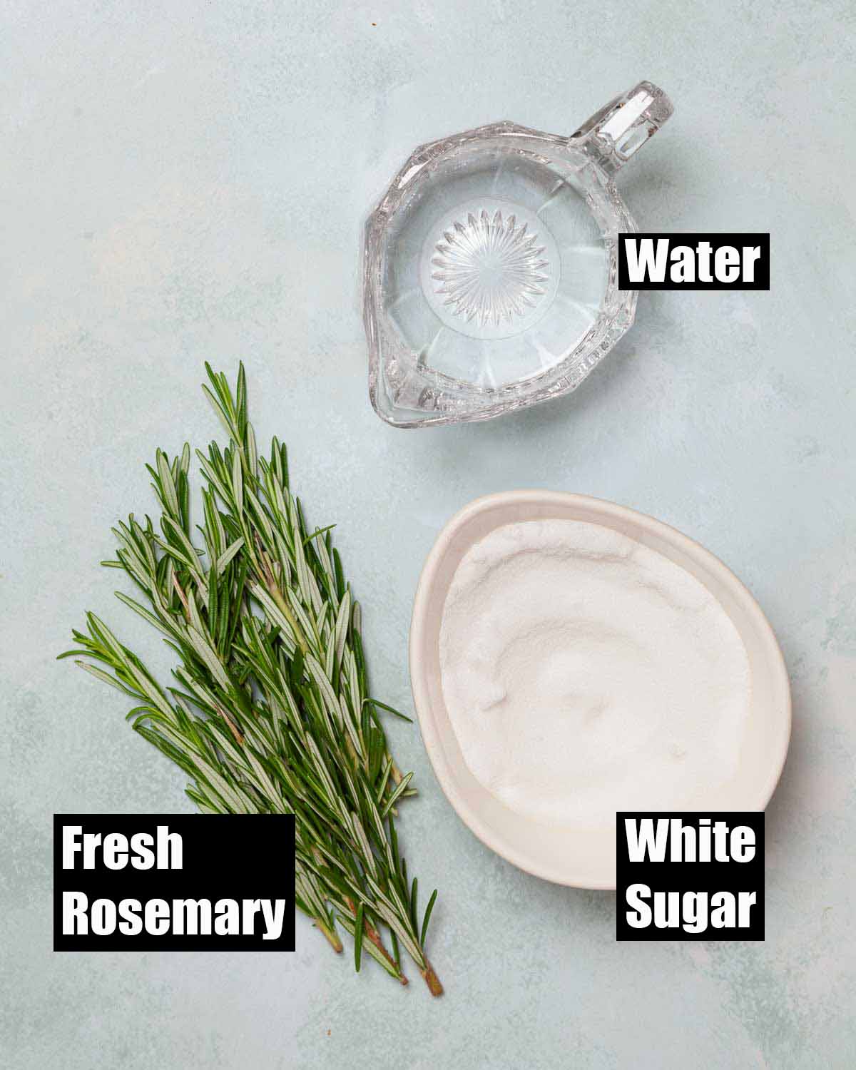 Labelled ingredients for homemade rosemary syrup for cocktails.